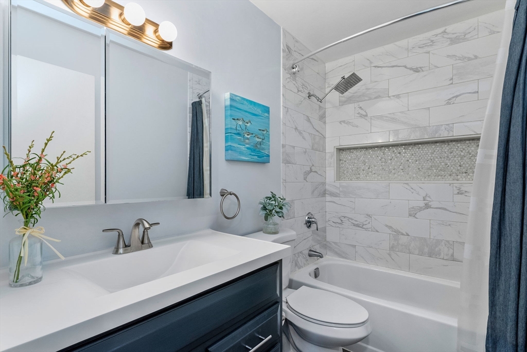 69 East Berkeley Street, Unit 5 Boston, MA 02118 - Photo 15 of 27 a bathroom with a sink toilet a mirror and shower