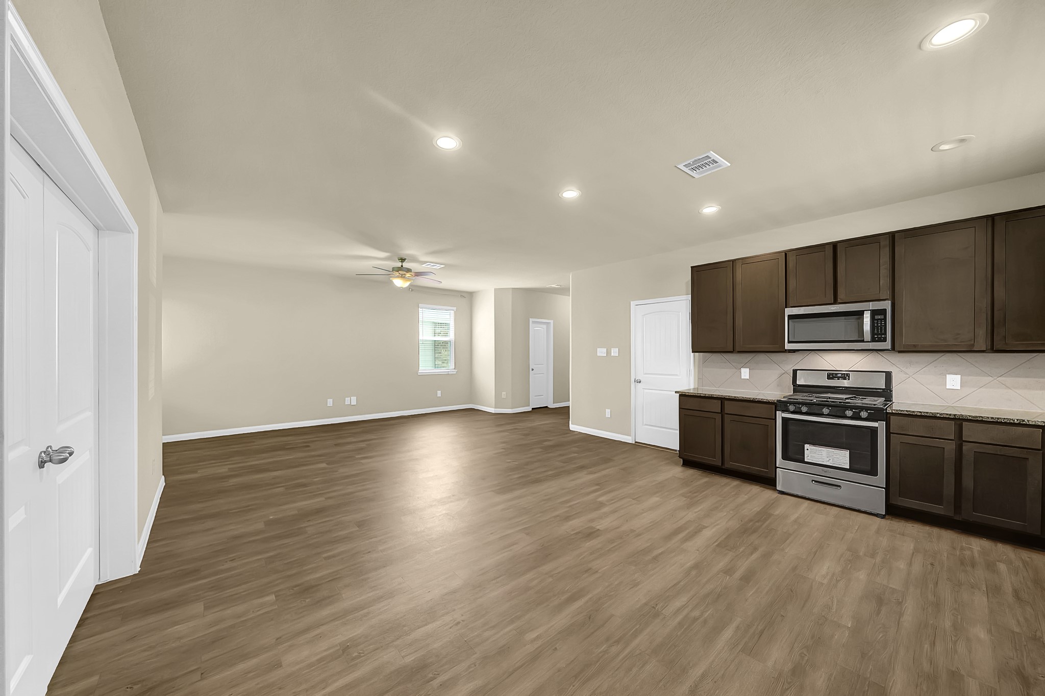 4274 McGregor Blf Lane Conroe, TX 77304 - Photo 5 of 25 a kitchen with stainless steel appliances granite countertop a stove a sink and a refrigerator
