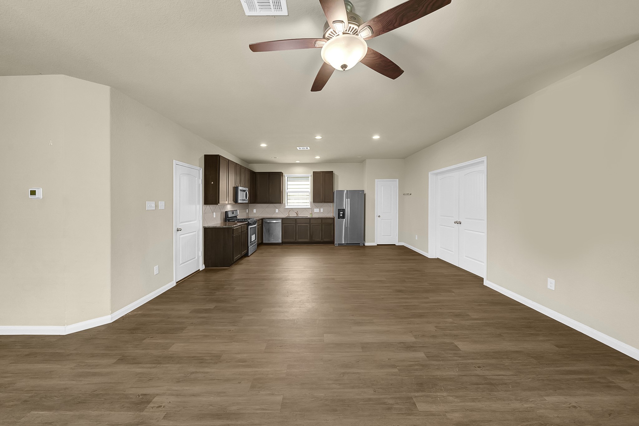 4274 McGregor Blf Lane Conroe, TX 77304 - Photo 8 of 25 a view of kitchen with refrigerator stove and cabinets