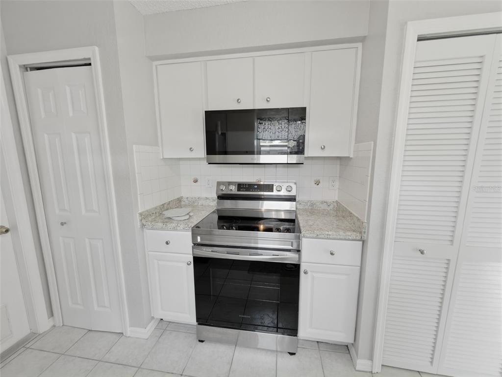 2202 Godfrey Avenue Spring Hill, FL 34609 - Photo 16 of 36 a kitchen with cabinets stainless steel appliances and a counter top space