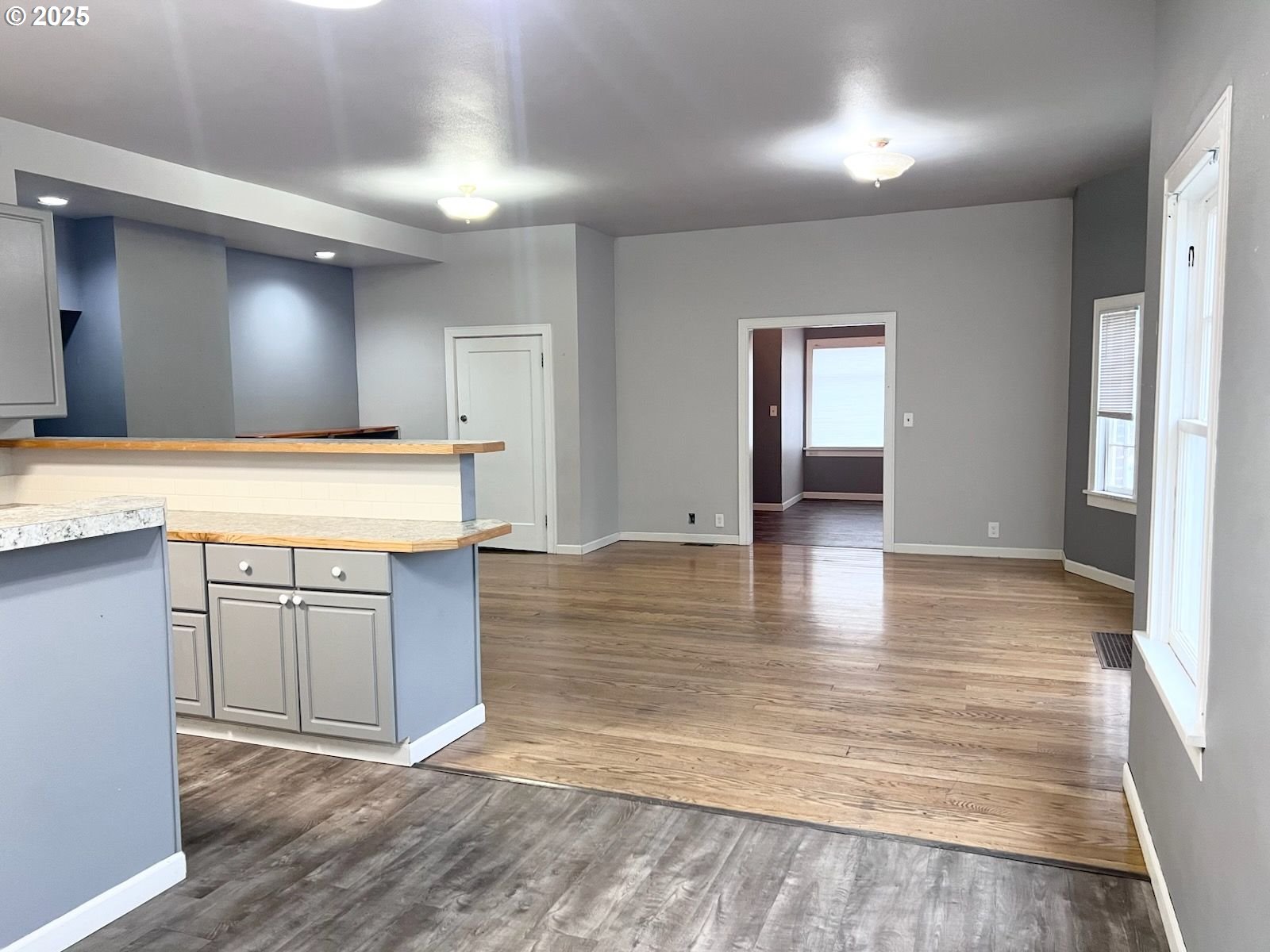 315 Gale Street Heppner, OR 97836 - Photo 17 of 44 a view of a kitchen with kitchen island a sink wooden floor and a refrigerator