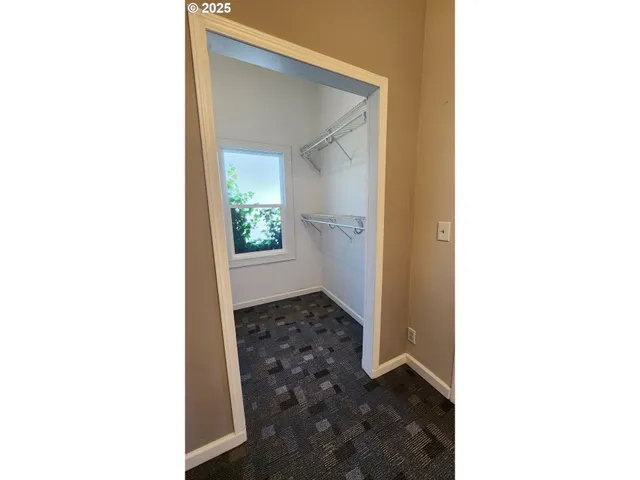 a view of a hallway with washer and dryer