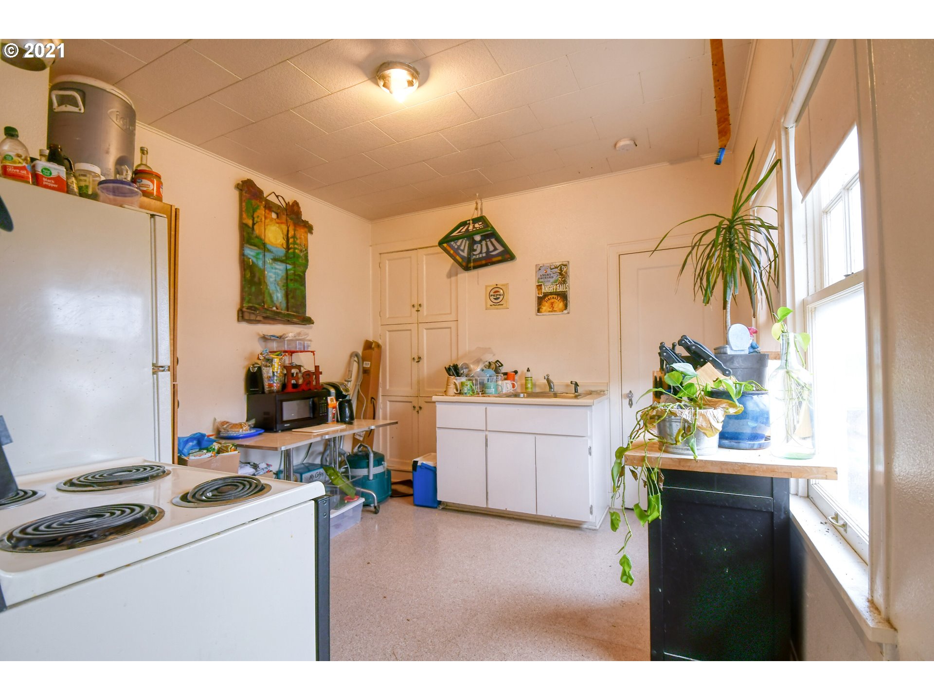 315 Gale Street Heppner, OR 97836 - Photo 8 of 44 a kitchen with kitchen island a stove a sink and a dining table