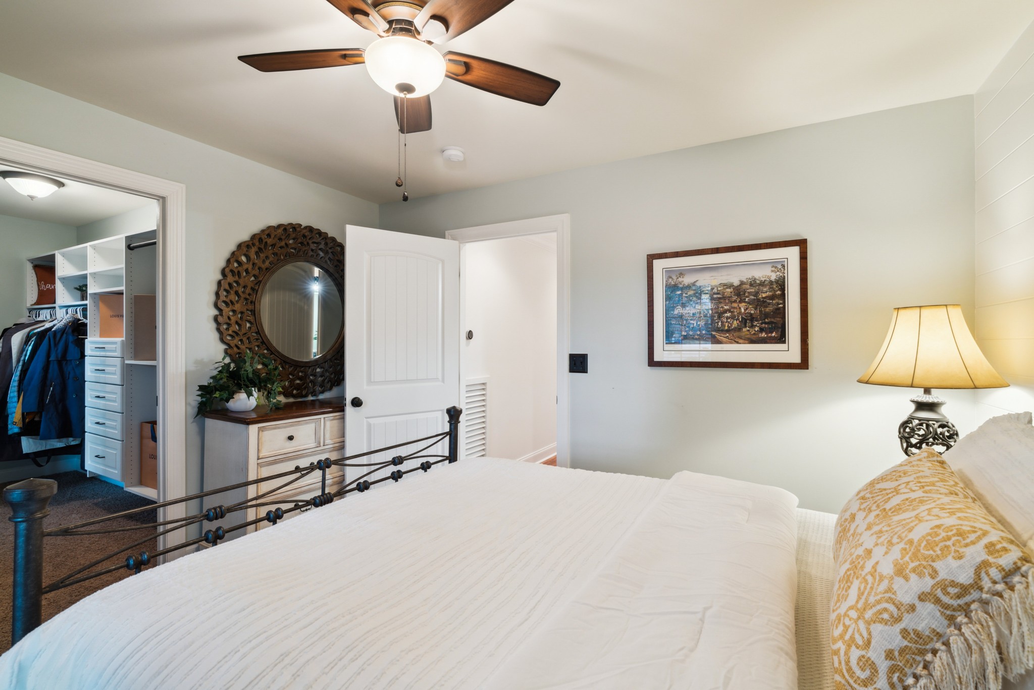 5224 Rustic Way Old Hickory, TN 37138 - Photo 21 of 56 a bedroom with a bed a mirror on the dresser and a chandelier