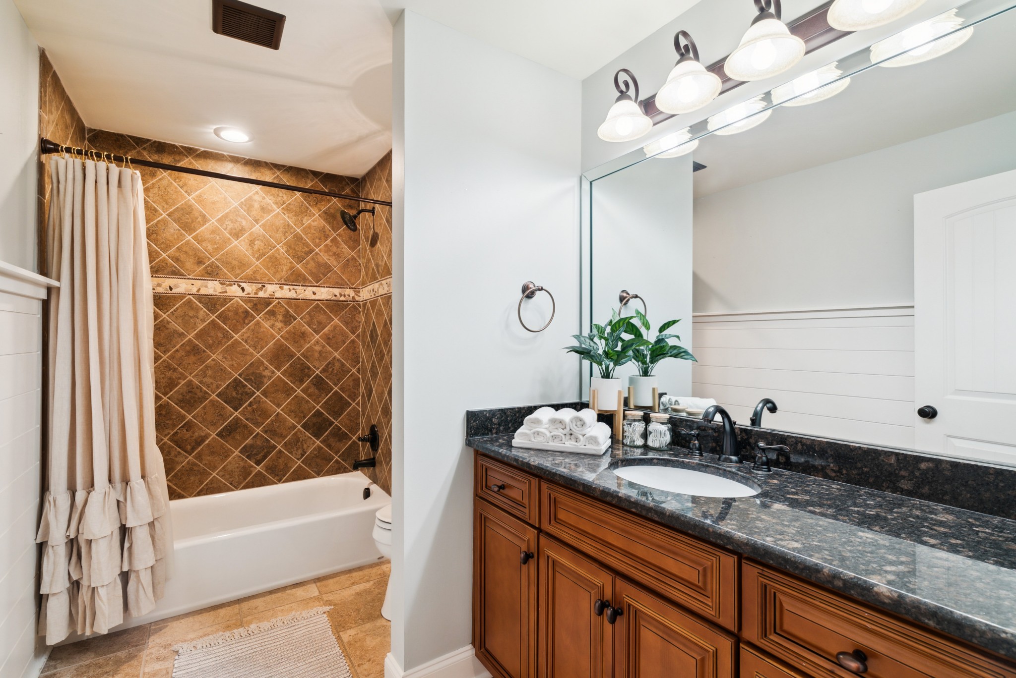5224 Rustic Way Old Hickory, TN 37138 - Photo 22 of 56 a bathroom with a granite countertop sink a large mirror and a bathtub