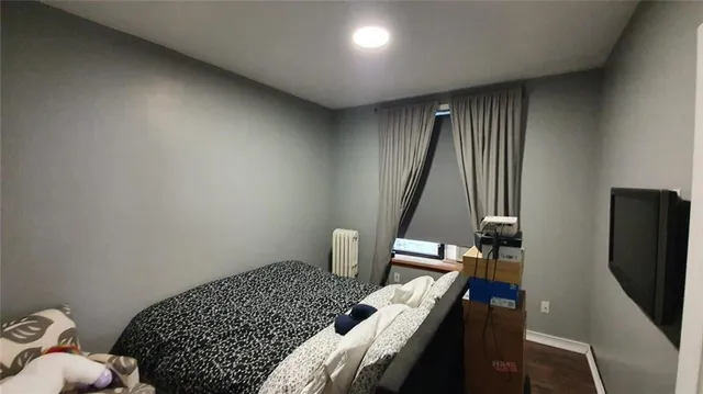 a bedroom with bed and a window