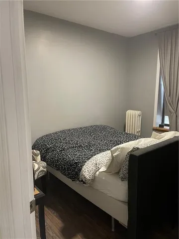 a bedroom with a bed and window