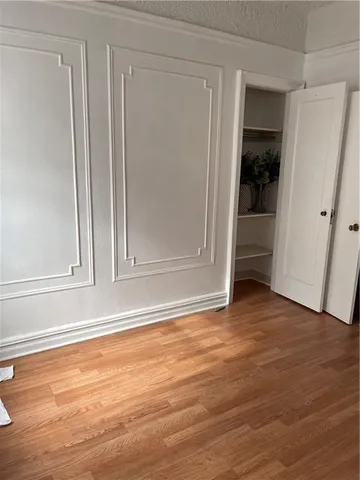 a view of wooden floor and closet in a room