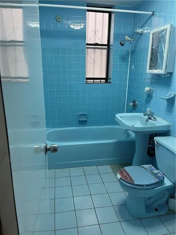 a bathroom with a toilet a sink and bathtub