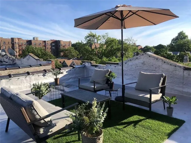 a view of a yard with furniture and a garden