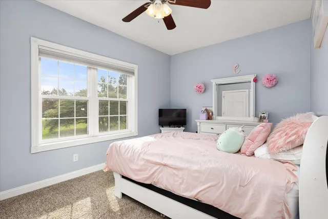 a bedroom with a bed dresser and a window