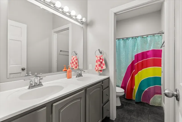 a bathroom with a sink vanity and a mirror
