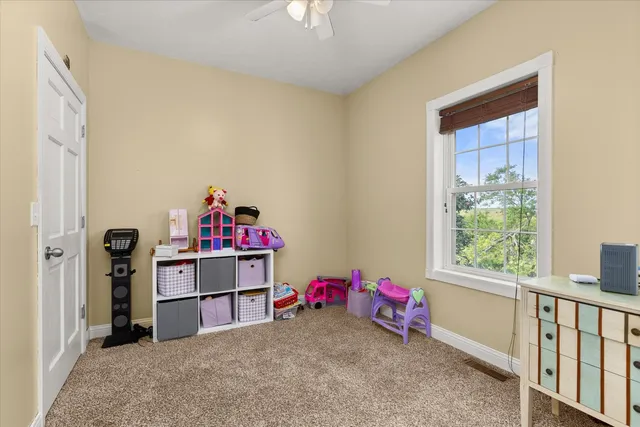 a view of a room with baby crib and toys