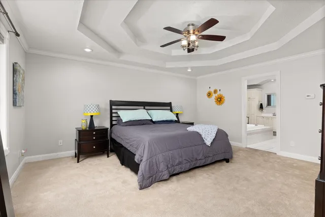 a bedroom with a bed and a ceiling fan