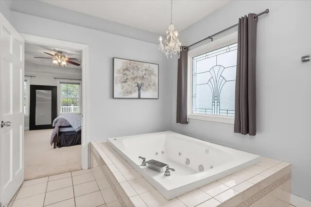 a bath tub sitting in a bathroom next to a window