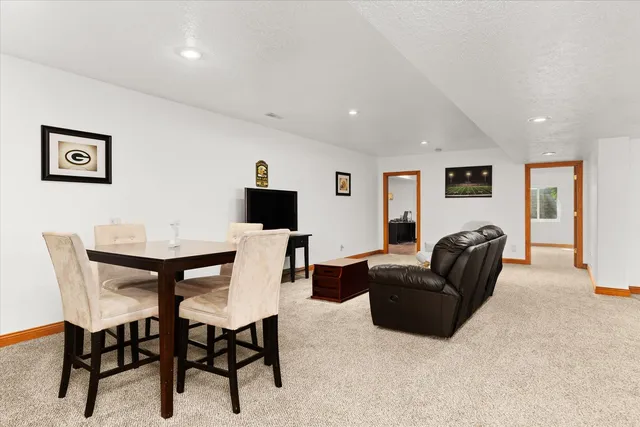a living room with furniture a flat screen tv and a table