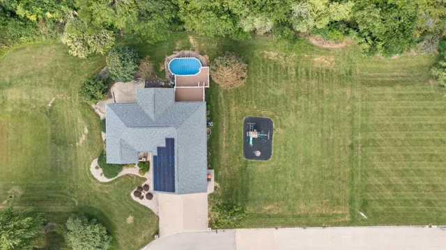 an aerial view of a house with a yard