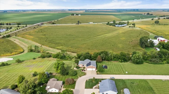 an aerial view of a house with a swimming pool and garden