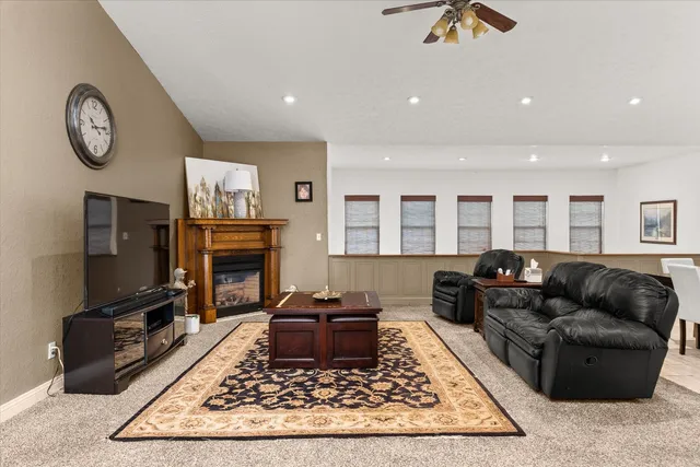 a living room with furniture a rug a flat screen tv and a fireplace