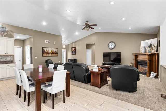 a living room with fireplace furniture and a flat screen tv