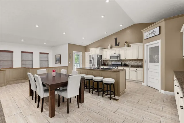 a view of kitchen with cabinets table and chairs