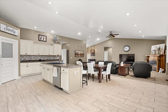 a large white kitchen with cabinets