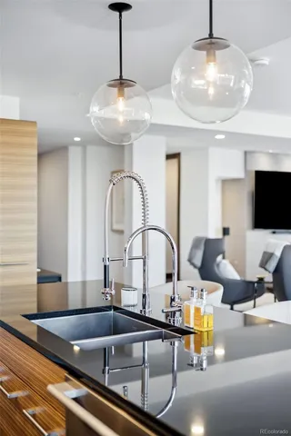 a kitchen with a sink and chandelier