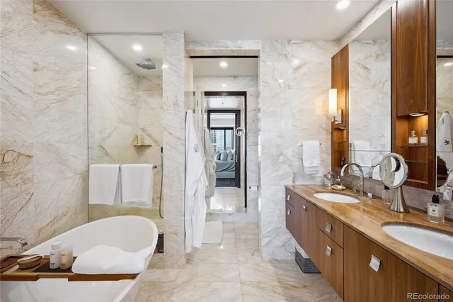 a bathroom with a granite countertop sink mirror and bathtub