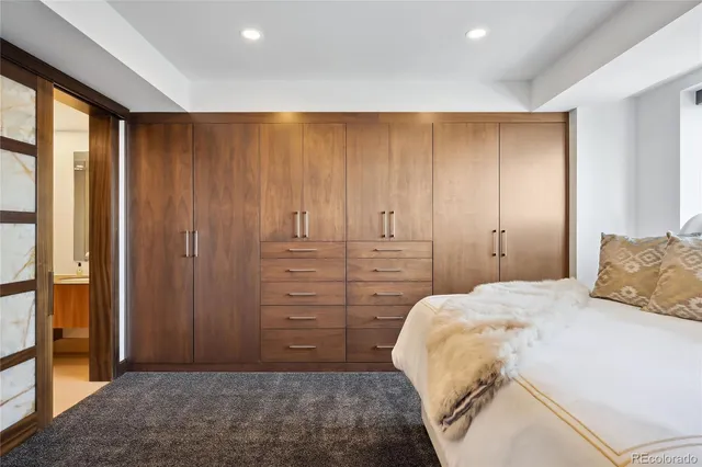 a bedroom with a bed and a cabinet