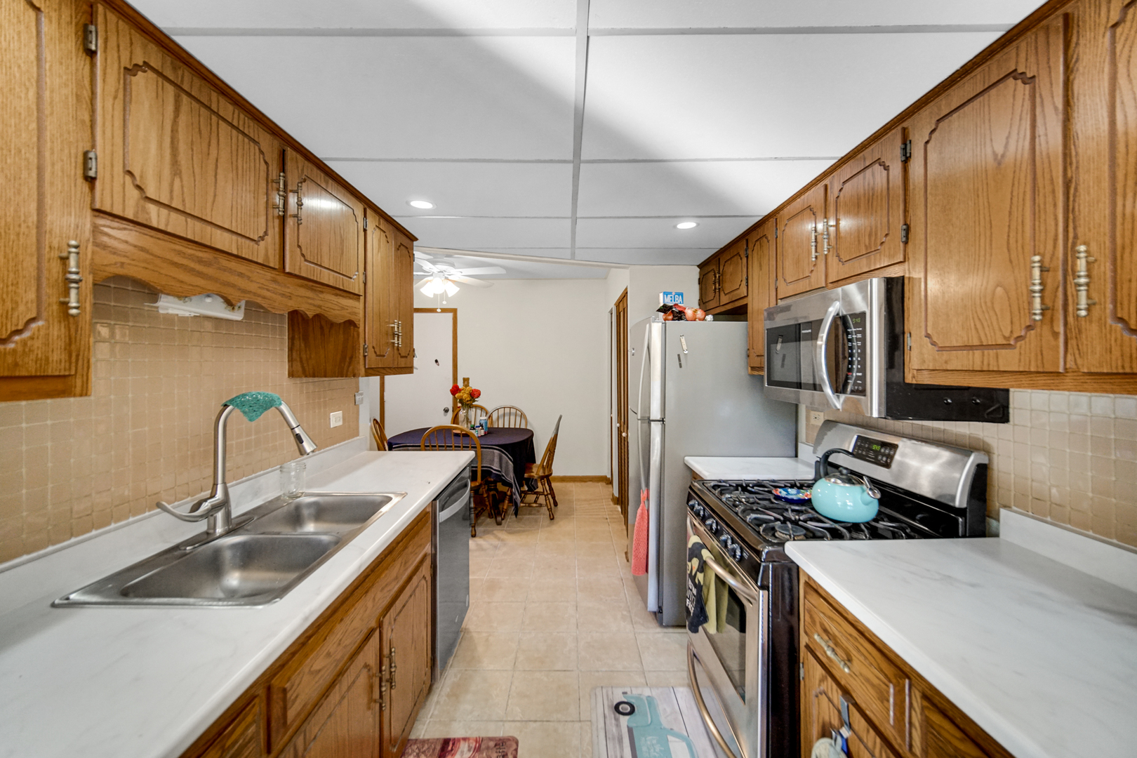 19159 Weber Road Mokena, IL 60448 - Photo 11 of 22 a kitchen with a sink a stove and a refrigerator