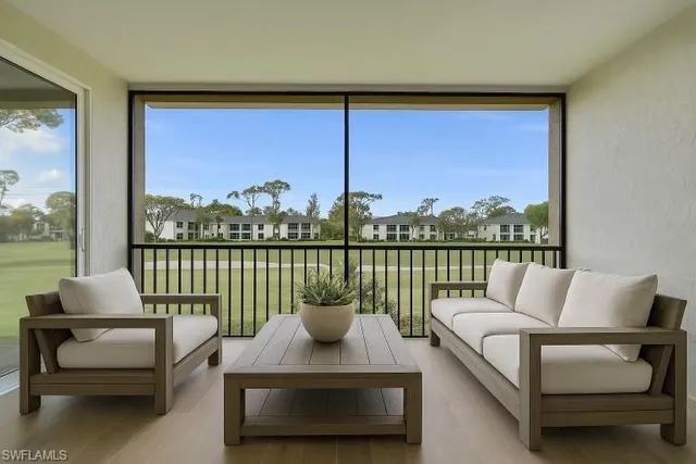 a living room with couch and a large window