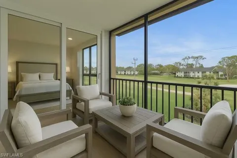 a balcony with furniture and a potted plant
