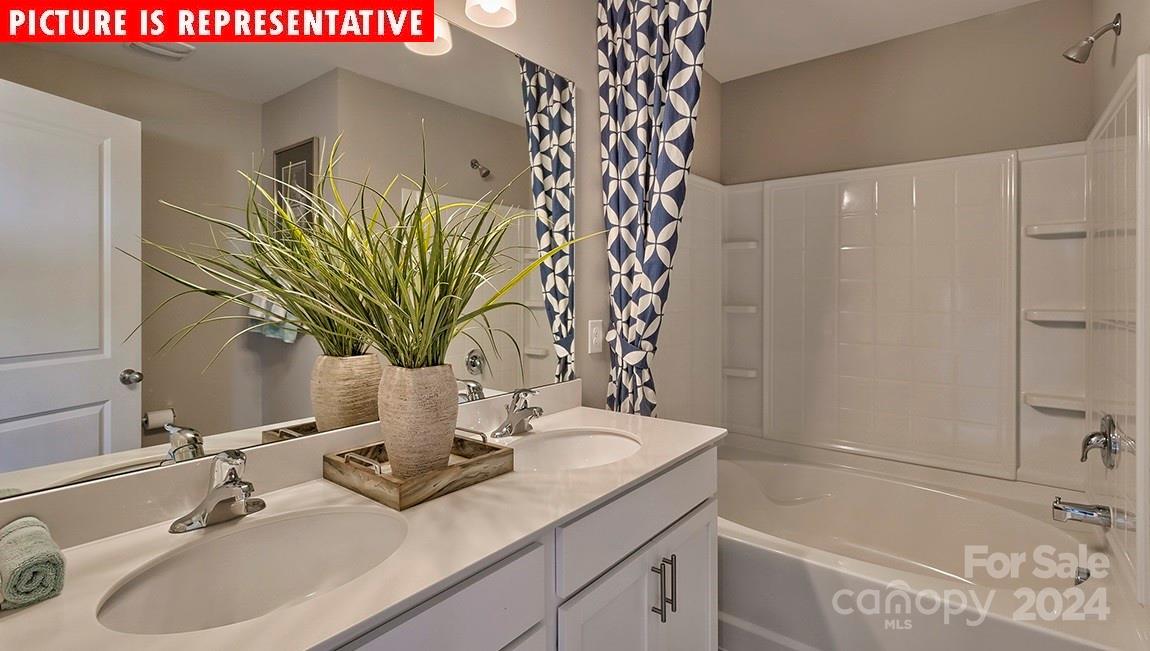 10921 Claystone Drive Davidson, NC 28036 - Photo 6 of 23 a bathroom with a sink a mirror and a shower