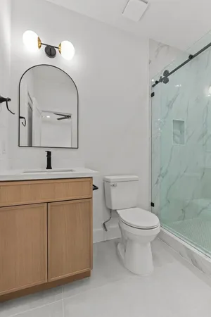 a bathroom with a toilet sink and mirror