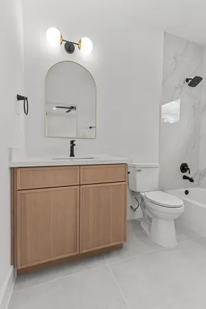 a bathroom with a sink a toilet and mirror