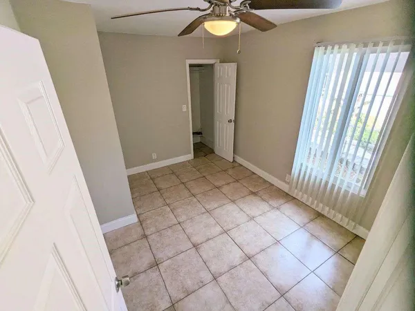 a view of an empty room and wooden floor