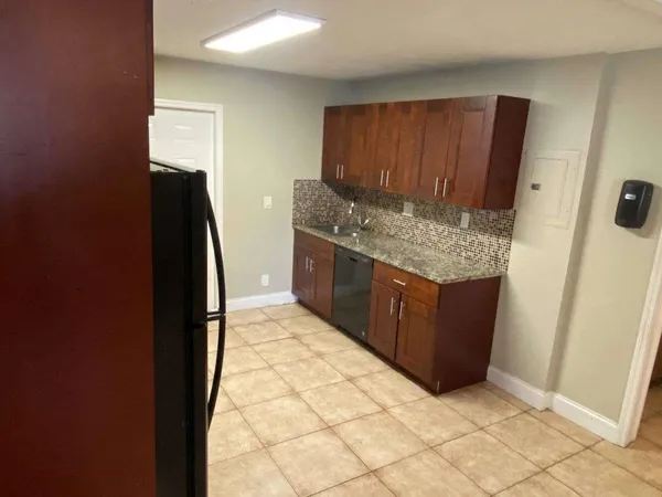 a kitchen with stainless steel appliances granite countertop a refrigerator and a stove