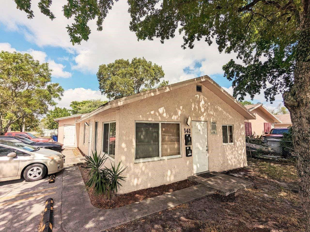 141 Northwest 10th Street Pompano Beach, FL 33060 - Photo 2 of 24 a view of a car in front of a house
