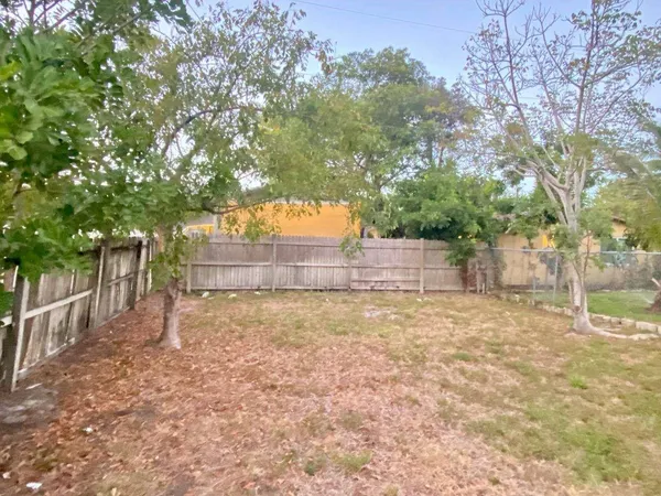 a backyard of house with large trees