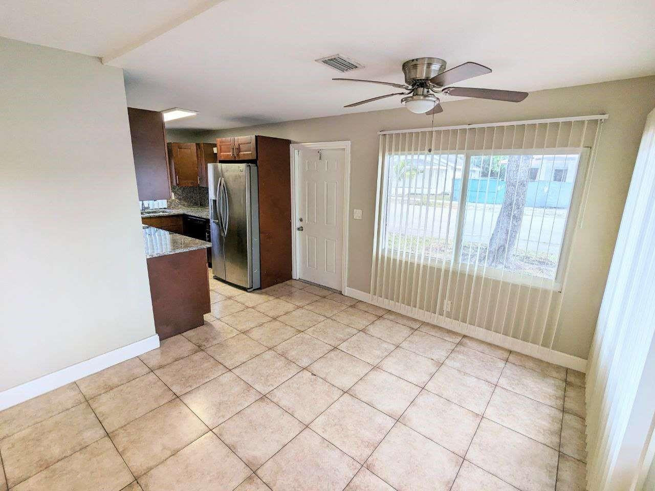 141 Northwest 10th Street Pompano Beach, FL 33060 - Photo 5 of 24 a view of a room with cabinet wooden floor and windows