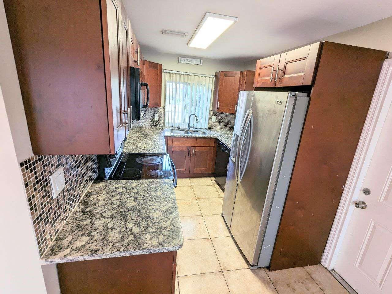 141 Northwest 10th Street Pompano Beach, FL 33060 - Photo 7 of 24 a view of kitchen with furniture and wooden floor