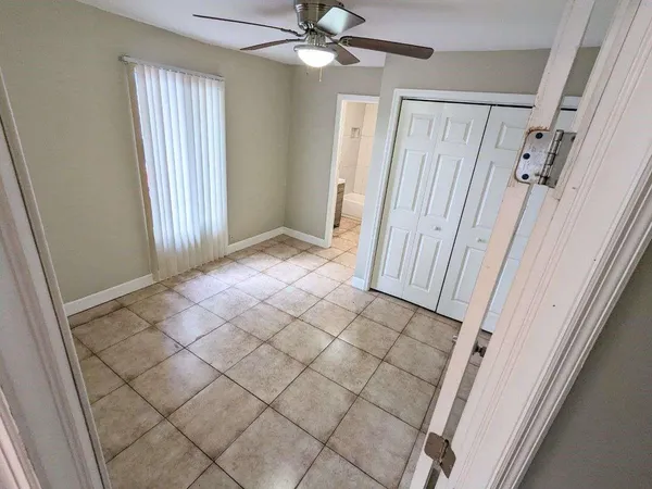 a view of a livingroom with a ceiling fan and window