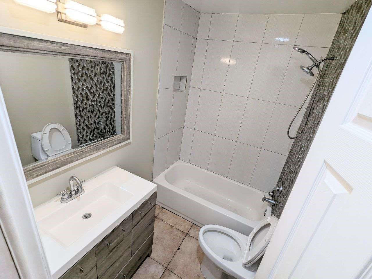 141 Northwest 10th Street Pompano Beach, FL 33060 - Photo 9 of 24 a bathroom with a sink a toilet and shower