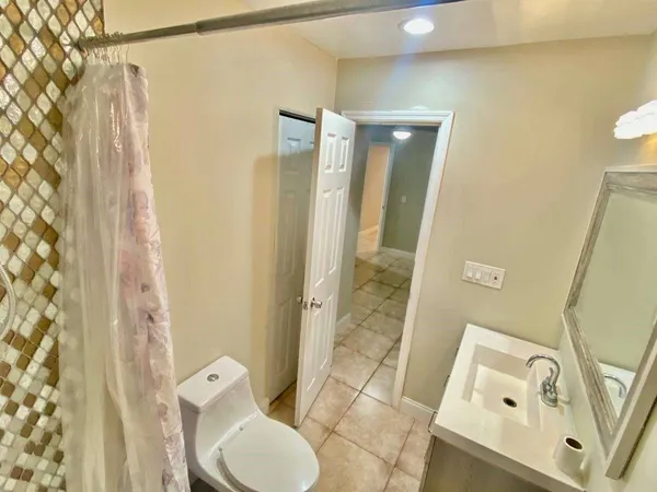 a bathroom with a toilet and a shower