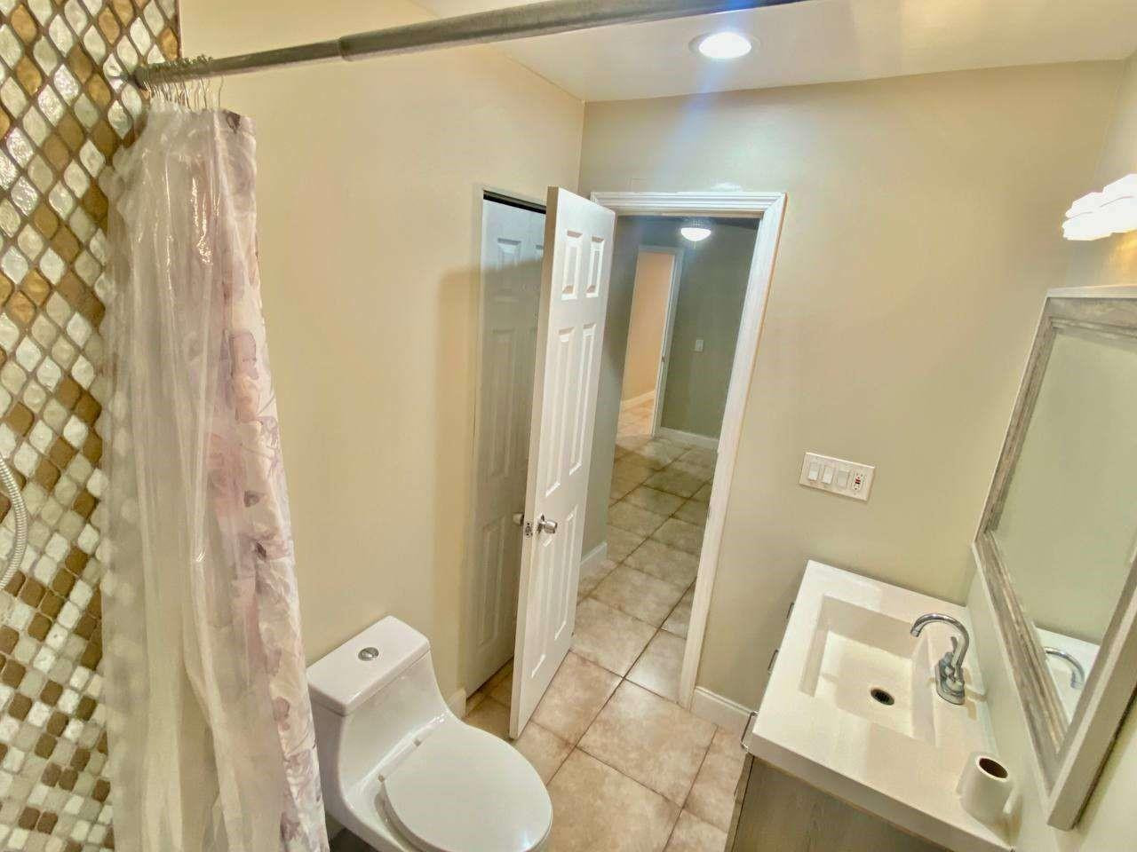141 Northwest 10th Street Pompano Beach, FL 33060 - Photo 10 of 24 a bathroom with a toilet and a shower