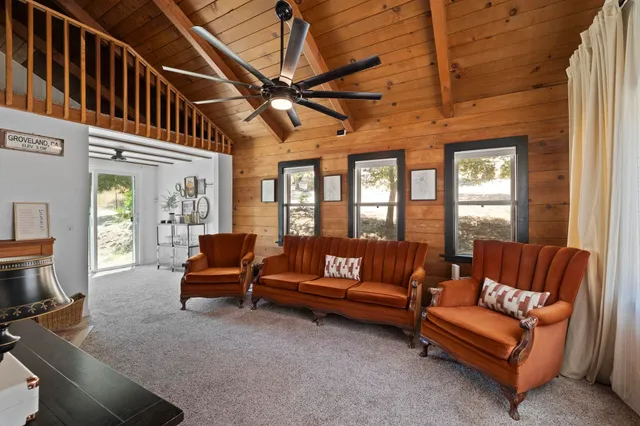 a living room with furniture ceiling fan and a window