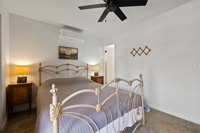 a bedroom with a bed and ceiling fan