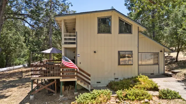 a backyard of a house with table and chairs