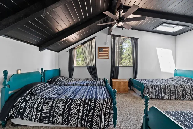 a bed sitting in a bedroom next to a window