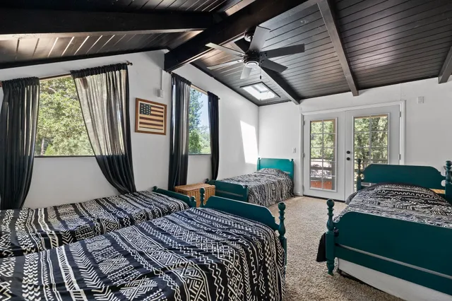 a bedroom with a bed next to a window